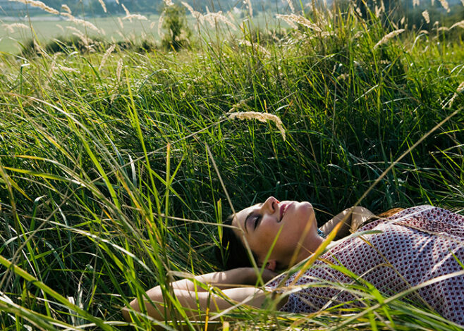 young woman lying in grass 2024 10 21 12 21 25 utc 658x470
